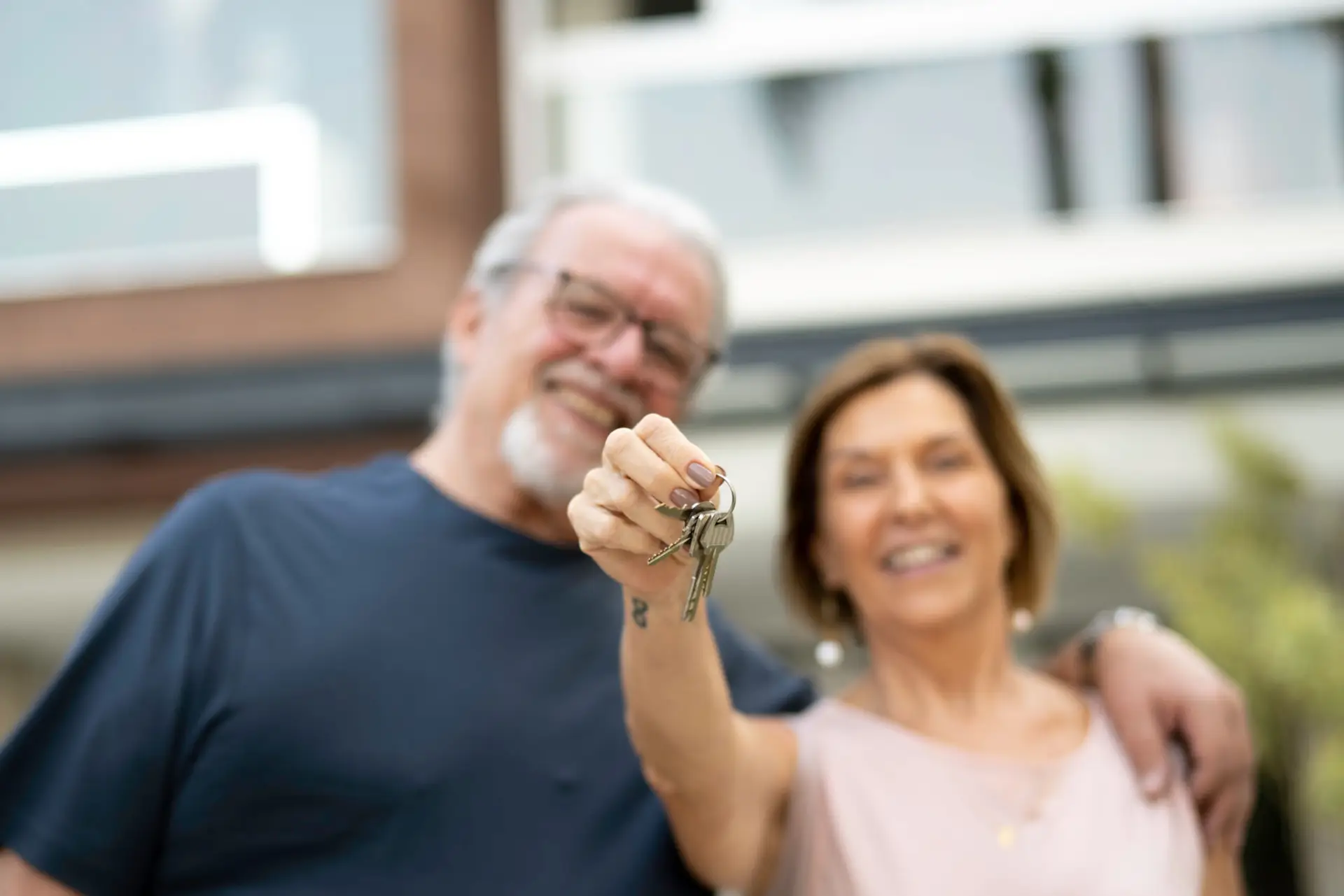 Mature couple holding the keys to their new home